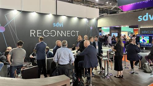 a group of people standing around a booth