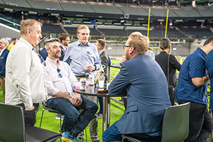 A Group Of Fans Excitedly Watching A Football Match At NAB 2024 In The Stadium