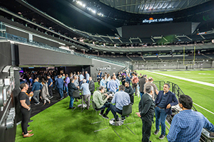 A Large Group Of People Standing Around In A Stadium At NAB 2024