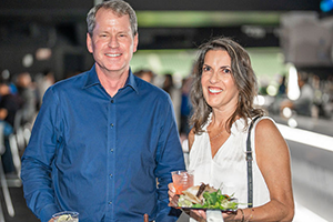 A Couple Holding A Plate Of Delicious Food At NAB 2024