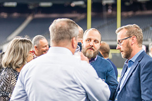 A Group Of Men Standing Next To Each Other On A Field At NAB 2024