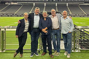 A Group Of Men Standing Next To Each Other On A Field At NAB 2024