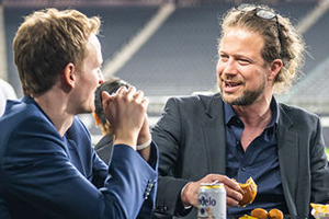 Two Friends Enjoying A Meal Together At A Table