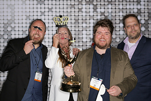 A Group Of People Standing Next To Each Other Holding A Trophy At NAB 2024