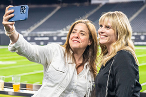 Two Women Taking A Picture With A Cell Phone At NAB 2024