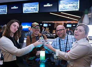 group of people standing around a table