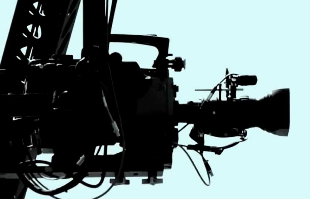 black and white photo of a camera on a tripod