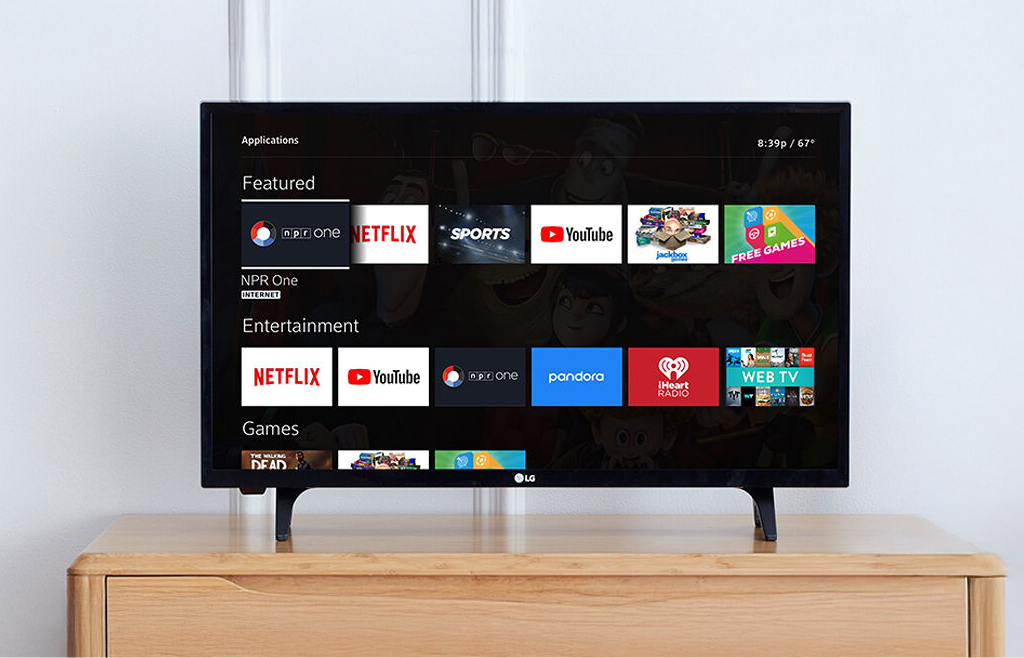 flat screen tv sitting on top of a wooden dresser