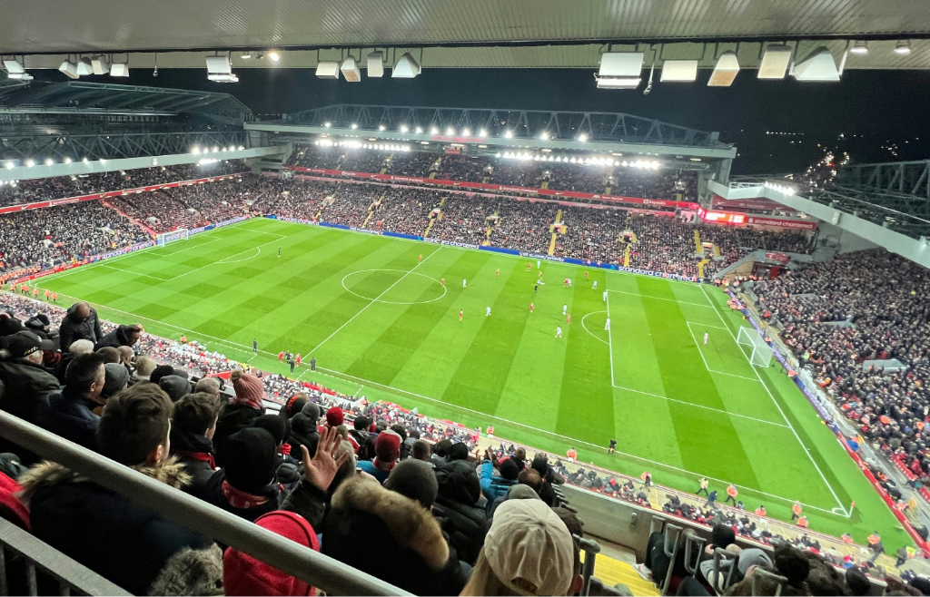 stadium filled with lots of people watching a soccer game