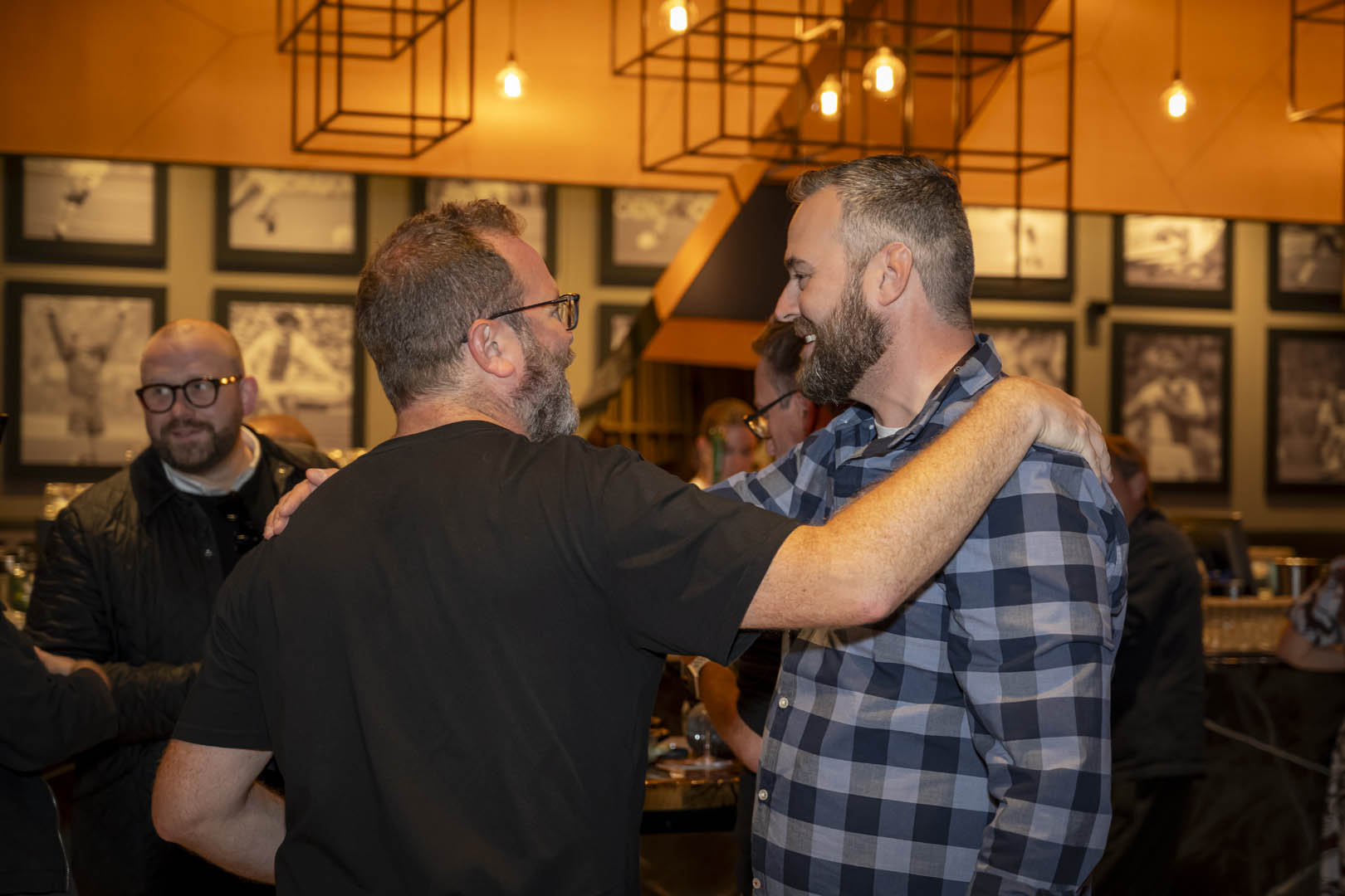 wo men shaking hands in front of flags